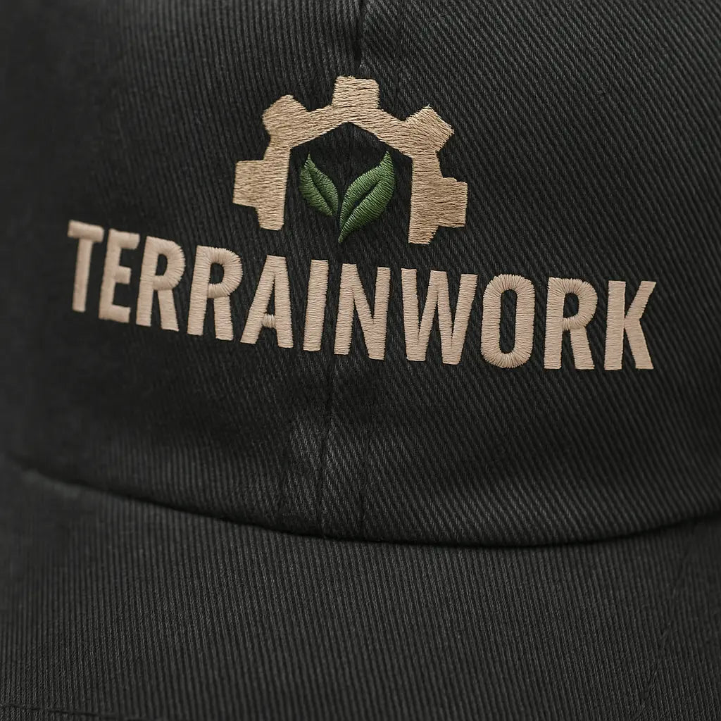 Front view of TERRAINWORK branded dad hat worn by landscaper, highlighting curved brim and embroidered details