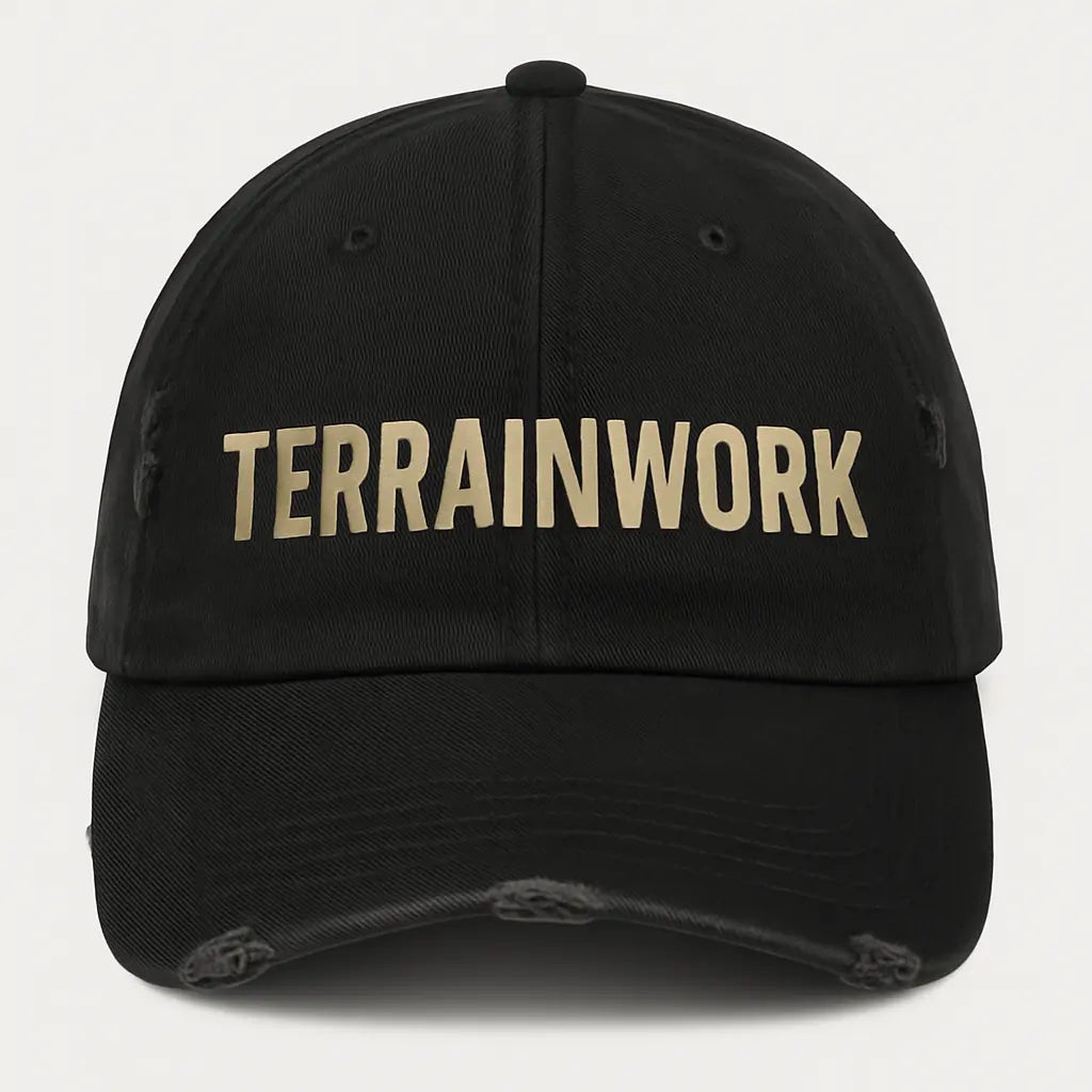 Distressed black TERRAINWORK dad hat with embroidered logo, front view on clean background